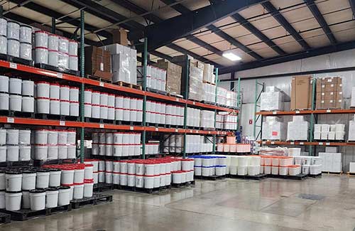 Warehouse full of concrete floor coating products.