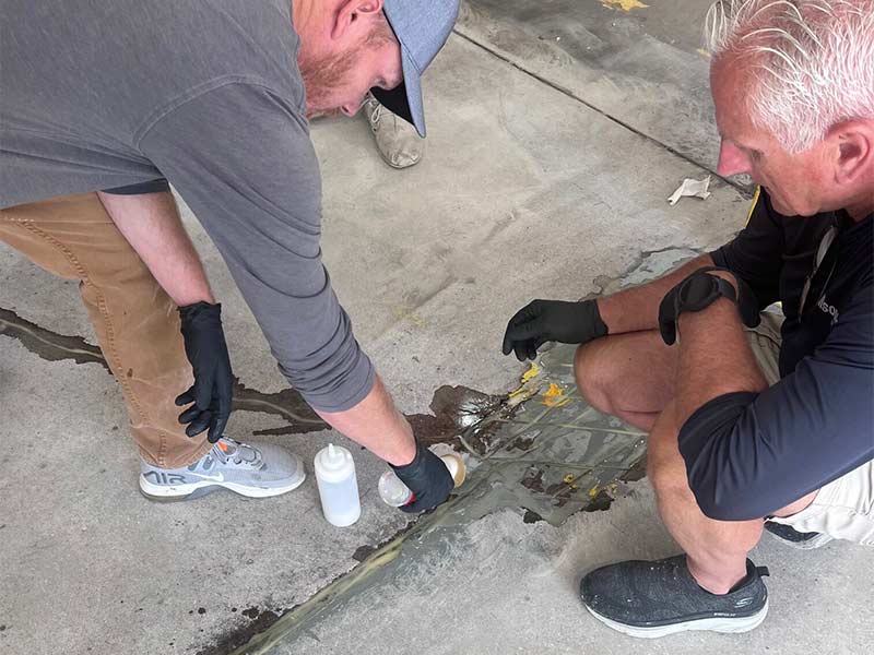 Applying mender to a cracked concrete floor