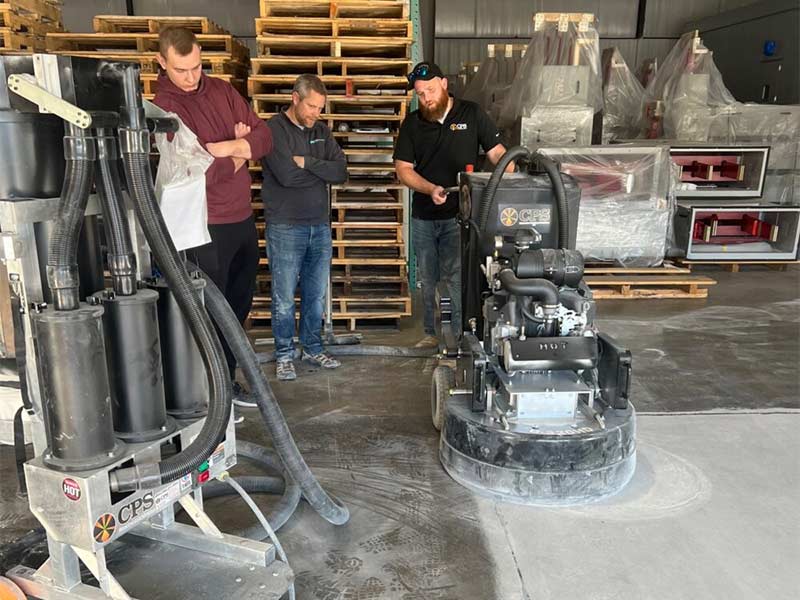 Group watching a demonstration about concrete polishing.